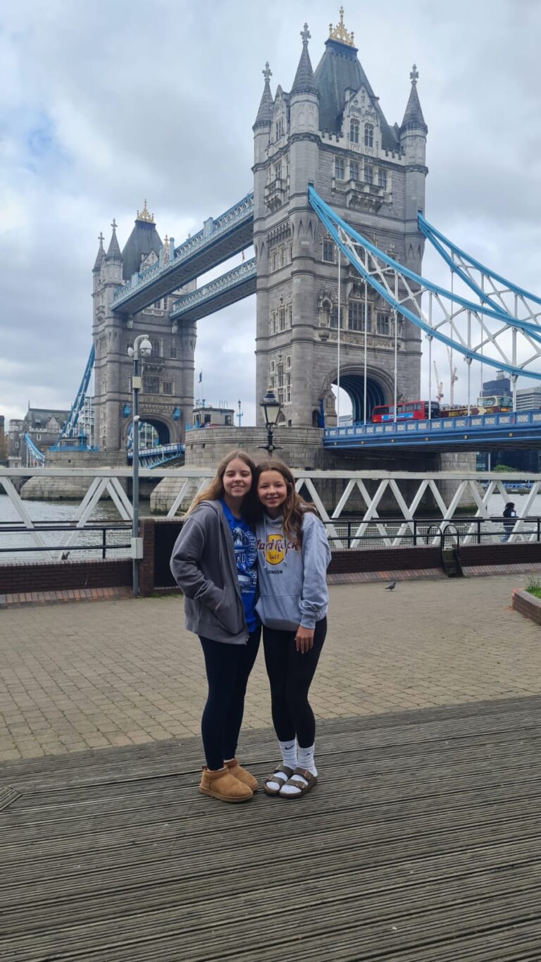 Tourists on guided tours of iconic London landmarks in a black taxi.