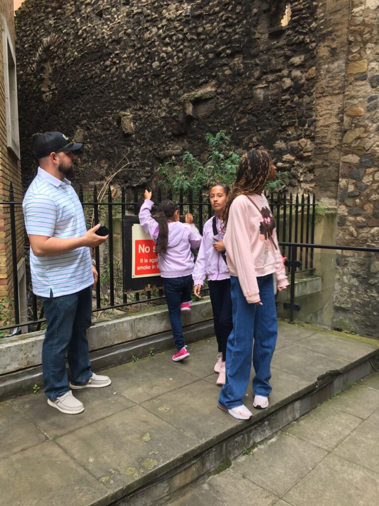 Tourists experiencing black cab sightseeing in London.