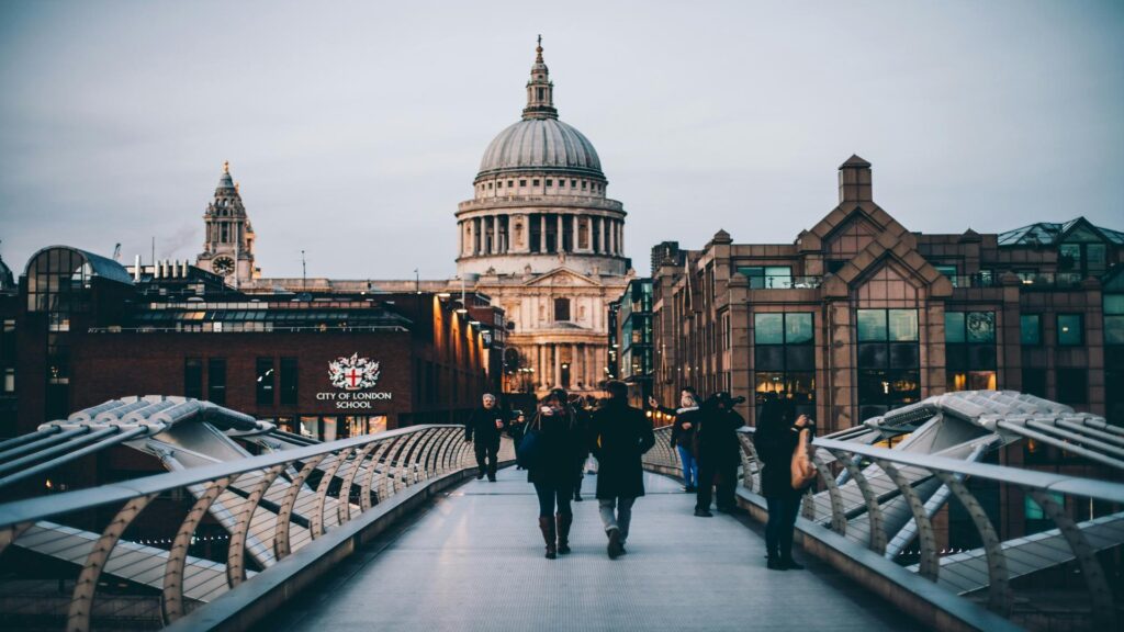 Photographer with tripod capturing St. Paul's Cathedral at sunset