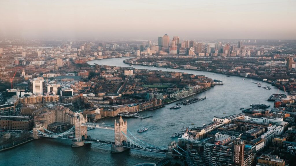 Solo traveler taking a selfie in front of Tower Bridge during a London taxi tour