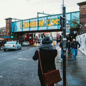 Tour guide pointing out London landmarks to tourists in a black cab