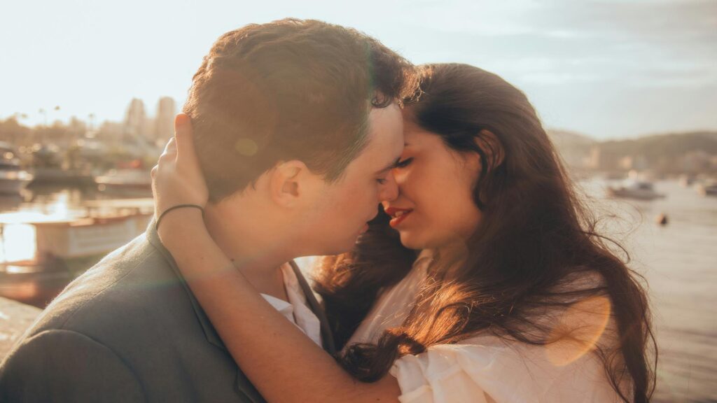 Couple enjoying a romantic sunset cruise on the River Thames with London landmarks in the background