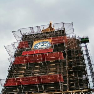 Big Ben clock tower covered in scaffolding during restoration work with iconic clock face visible