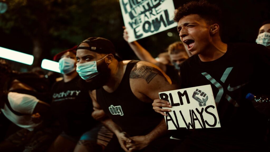 Protesters at a Black Lives Matter demonstration wearing face masks and holding signs