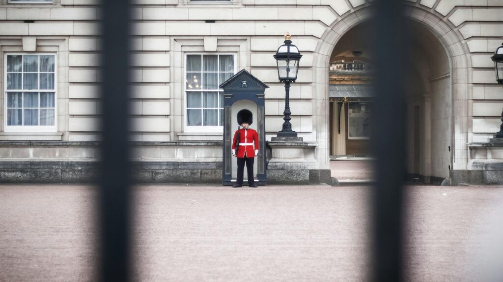 A guard in red uniform at Buckingham Palace