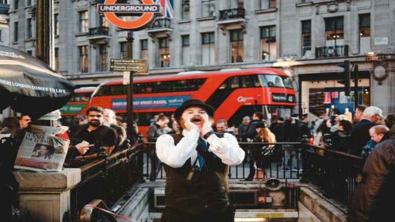 A lively London street with a red double-decker bus, a man shouting, and an Underground sign.