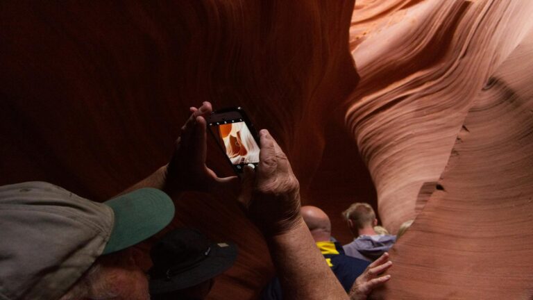 Tourists capturing the beauty of Antelope Canyon during a guided tour.