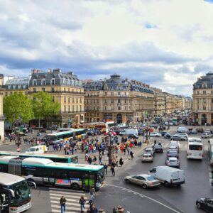 Busy city intersection with buses and pedestrians