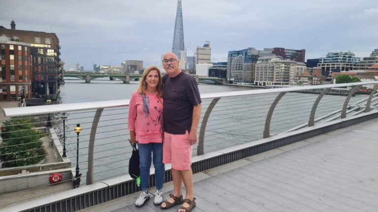 Couple enjoying London sightseeing with the Shard and Thames River in the background, highlighting tourist activities in London.