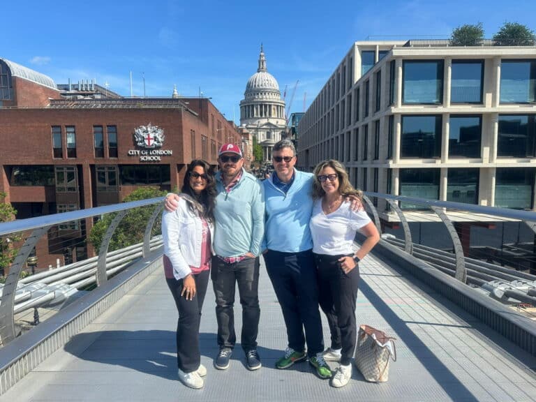 Group enjoying London Sites to Visit with St. Paul's Cathedral in the background from Millennium Bridge.