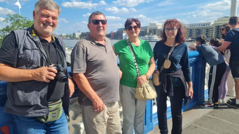 Group enjoying London sightseeing taxi tours with iconic city views in the background - Best London Sites To Visit