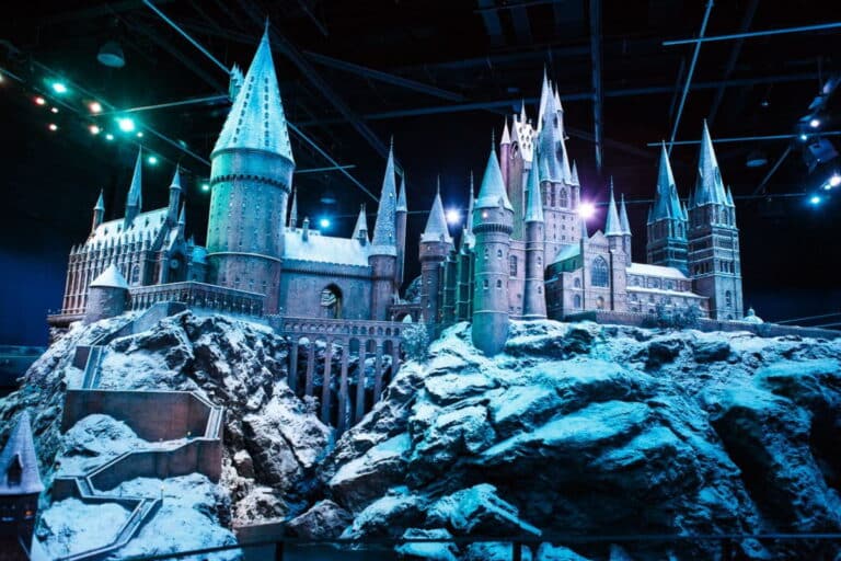 Hogwarts castle model covered in snow at Warner Bros. Studio Tour London, a must-see sight to visit in London