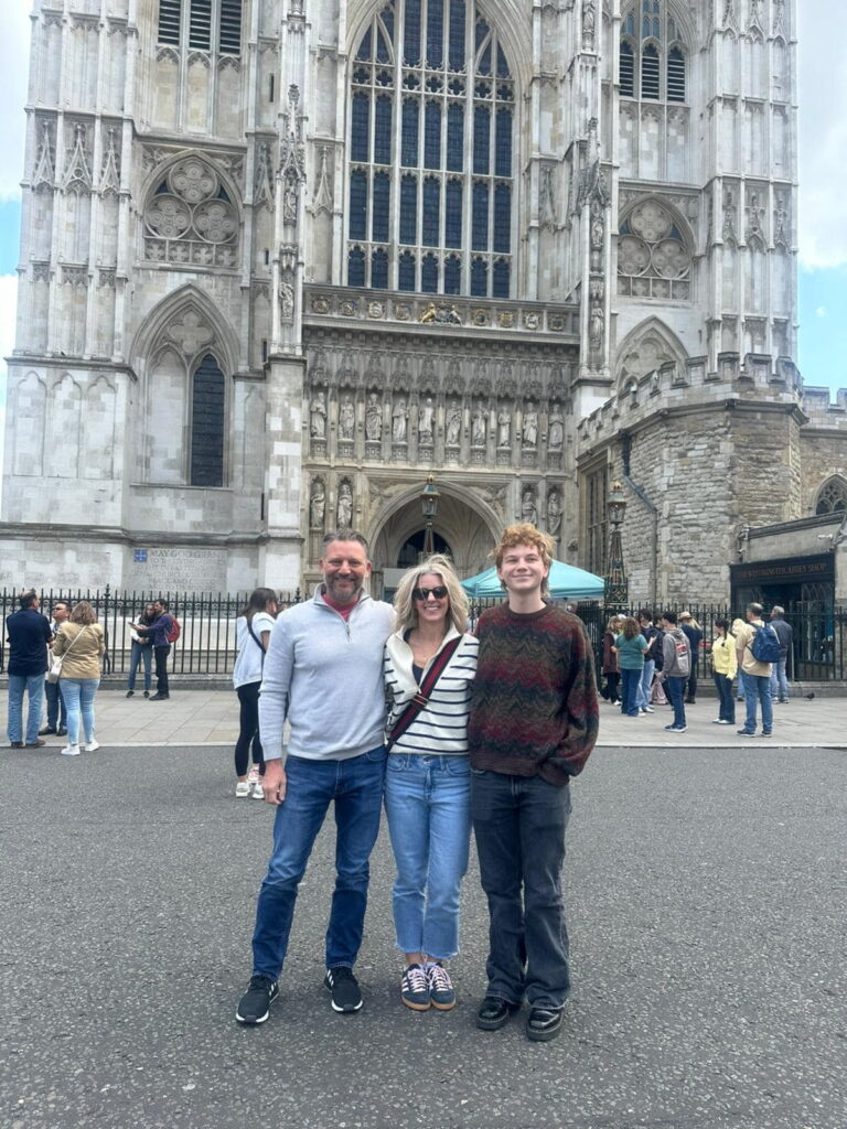 Tourists standing in front of Westminster Abbey, a historic landmark and popular place to sightsee in London.