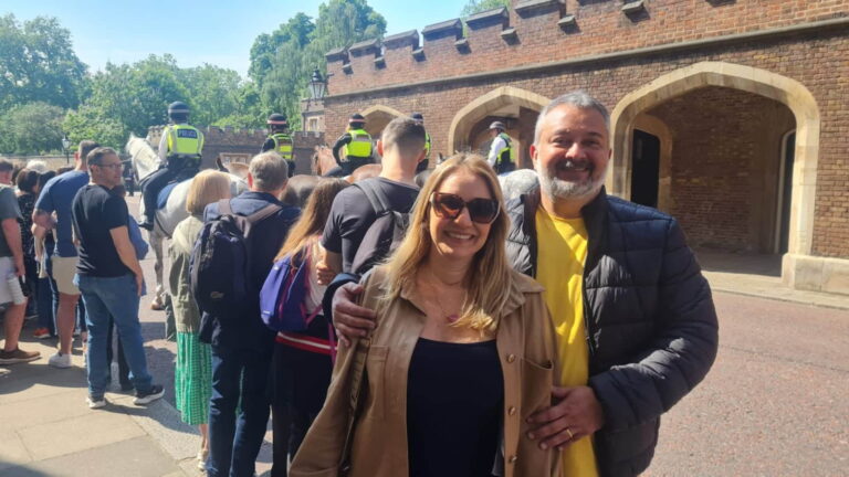 Visitors enjoying a tour near famous landmarks in London, England, with mounted police in the background.