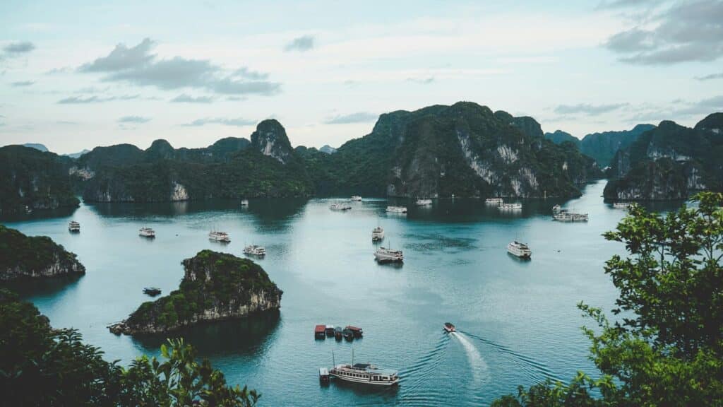 Boats touring a scenic bay surrounded by limestone islands