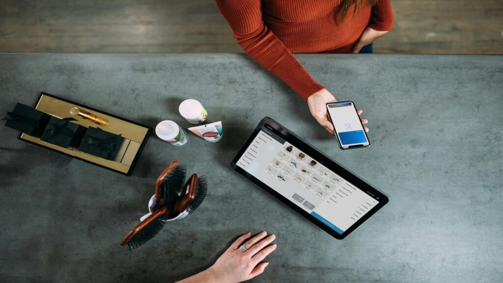 Customer making a payment using a smartphone at a counter