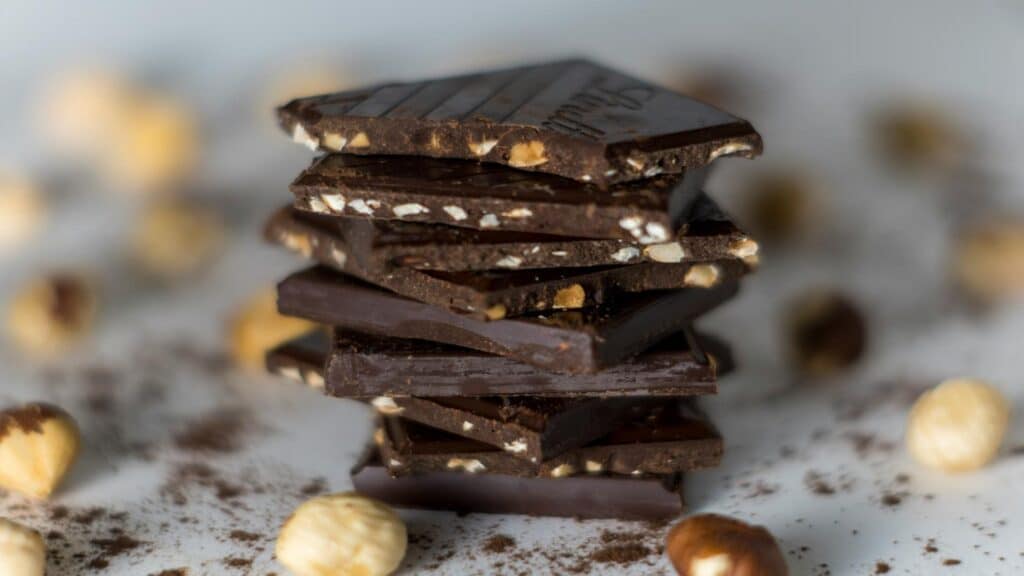 Stack of dark chocolate pieces with nuts