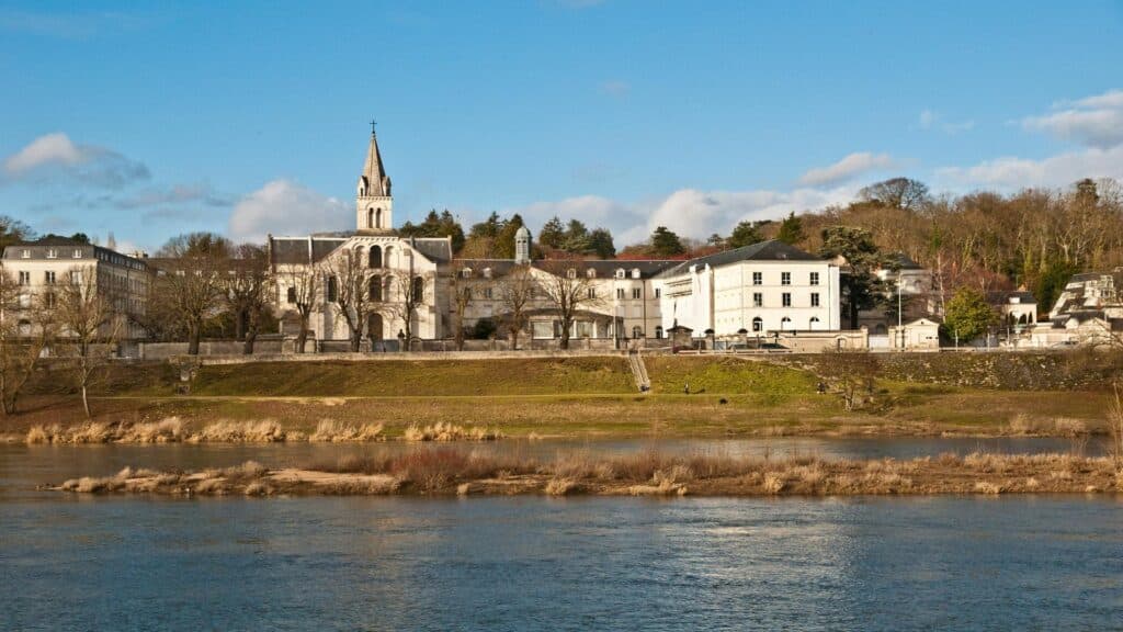 A scenic view of a historic church by the river