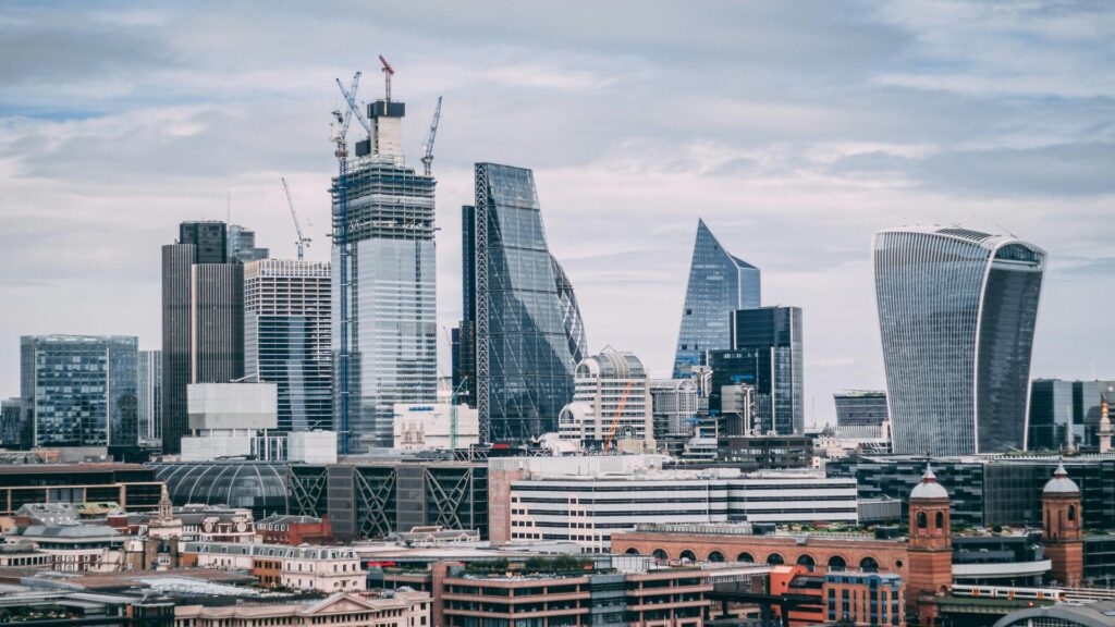 A view of London's modern skyline featuring iconic skyscrapers under a cloudy sky.