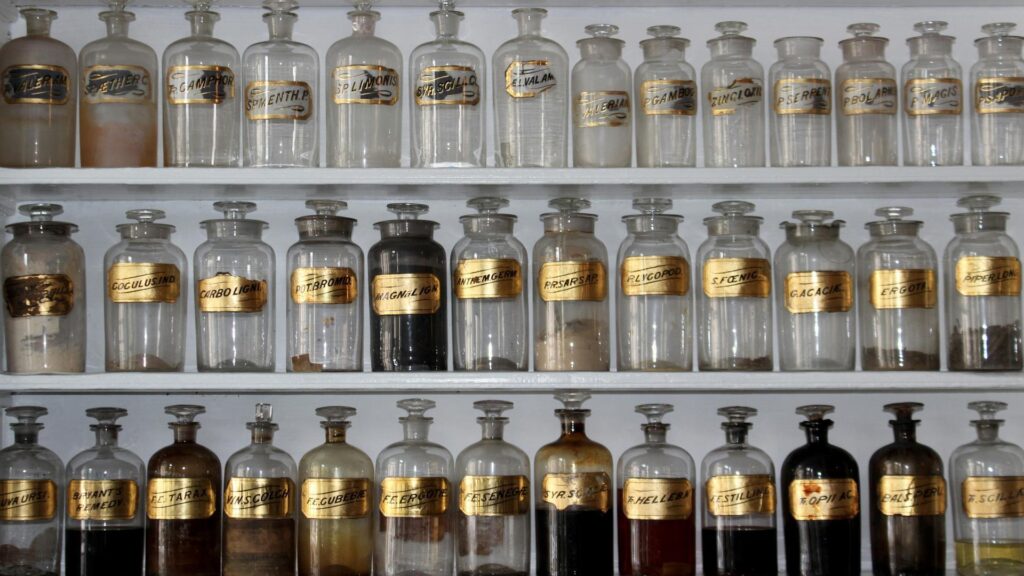 Collection of vintage apothecary bottles on shelves