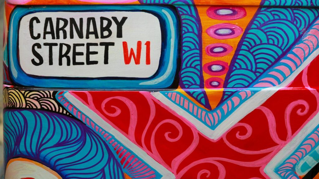 Vibrant artwork featuring Carnaby Street sign with colorful patterns.