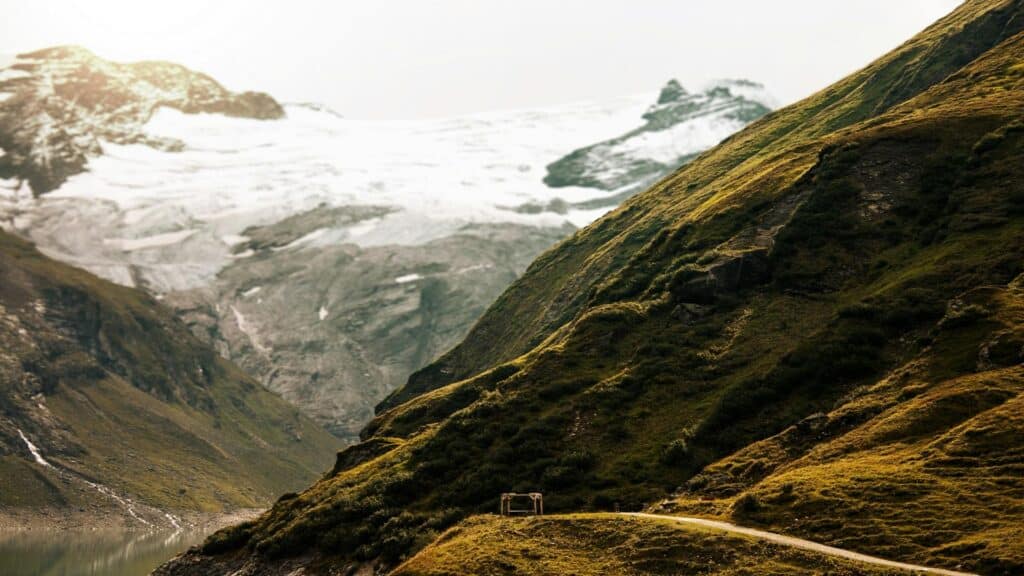 Mountain landscape with a glacier and grassy hills