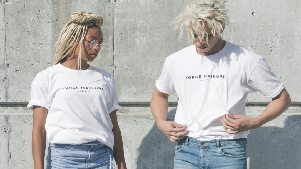 Two individuals wearing Force Majeure t-shirts during exhibition tours