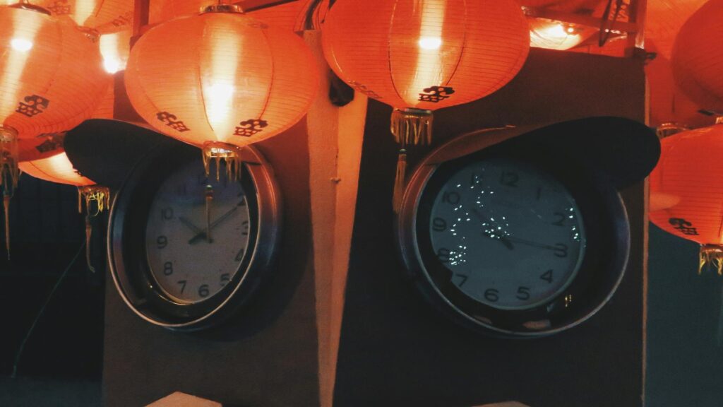 Two clocks under red lanterns