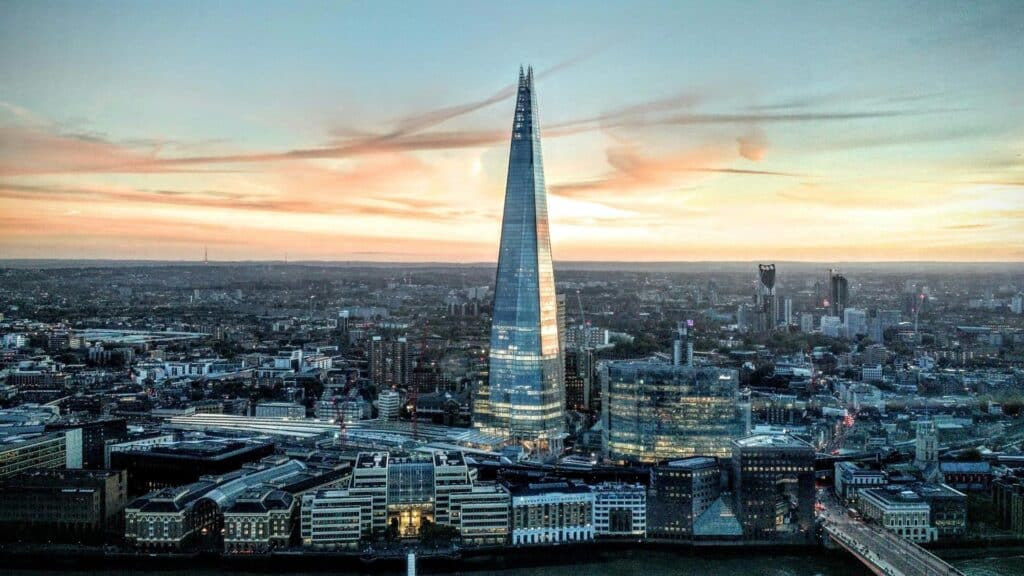 Aerial view of The Shard skyscraper in London during sunset with orange sky and cityscape