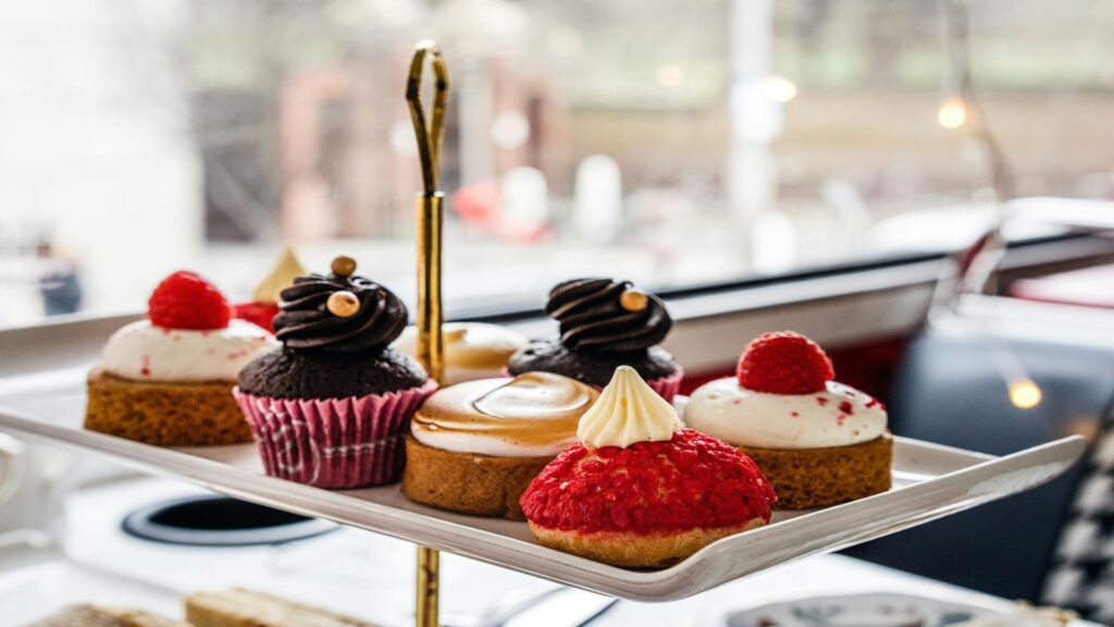 A tray of assorted kosher desserts including cupcakes and pastries.