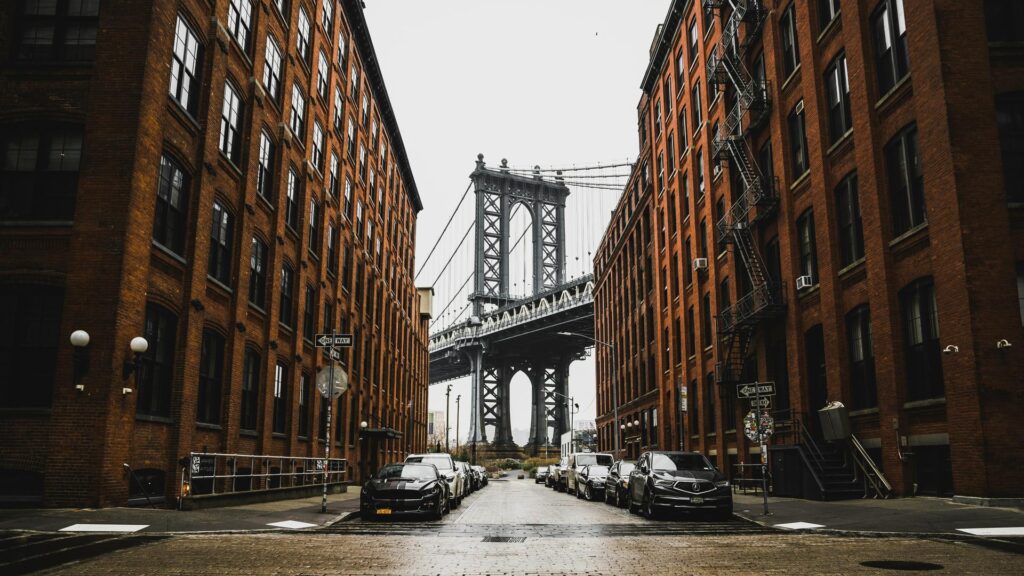 View of a bridge framed by brick buildings