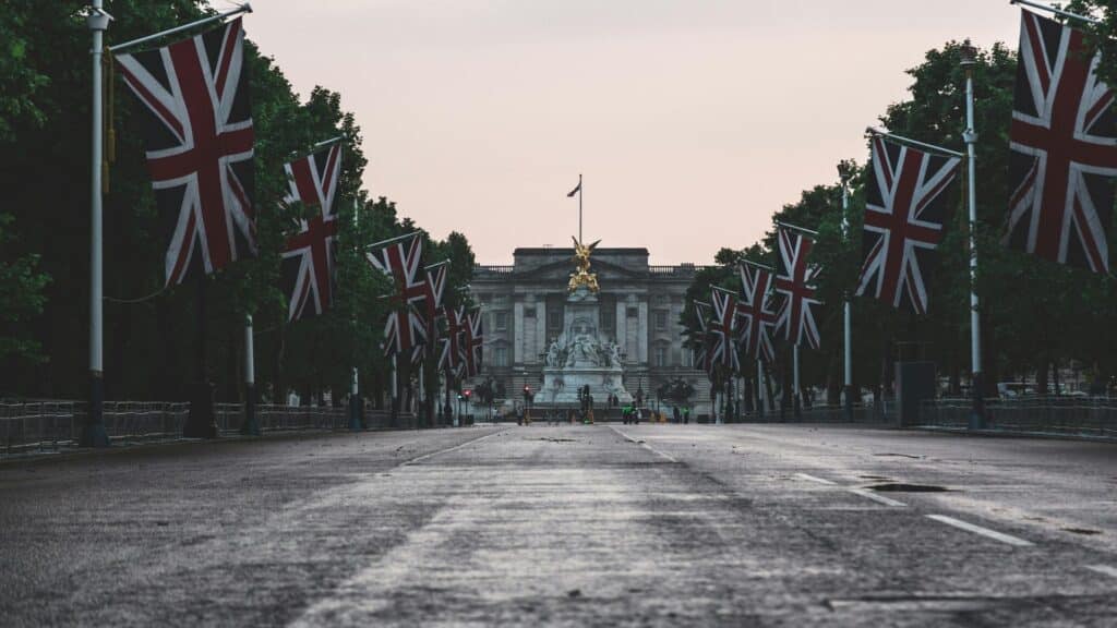 Rock Tours at Buckingham Palace: Union Jack flags lining The Mall with iconic palace facade