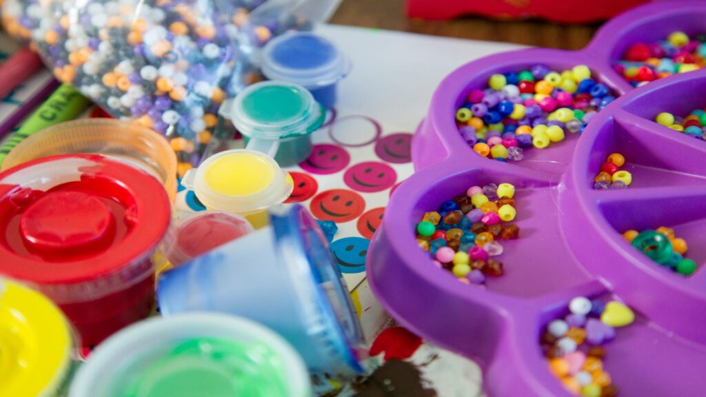 Close-up of colorful beads, paints, and craft materials.