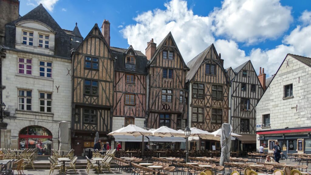 Medieval half-timbered houses in Place Plumereau, Tours, France with outdoor cafe seating