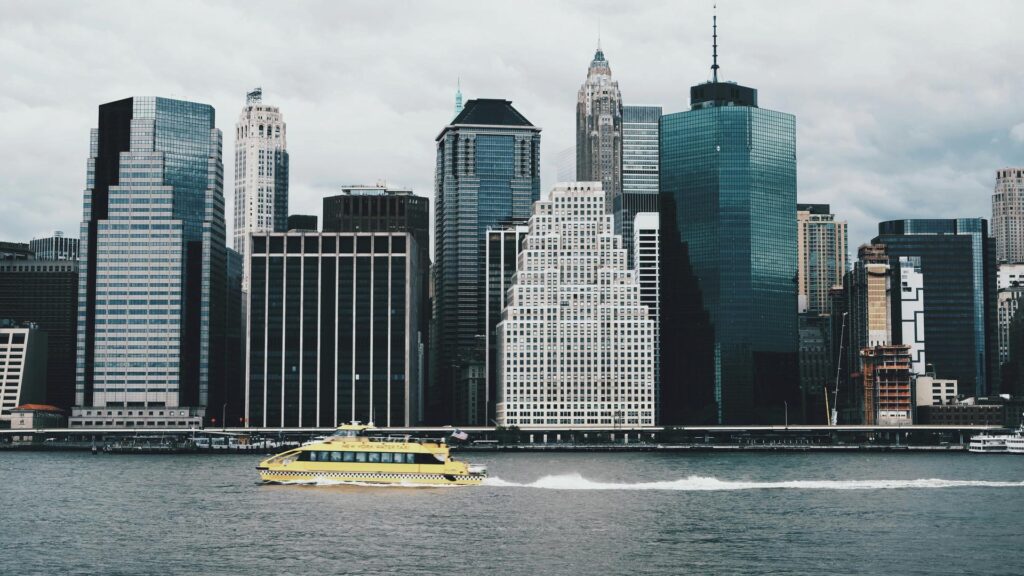 Skyline view with a yellow water taxi on the river