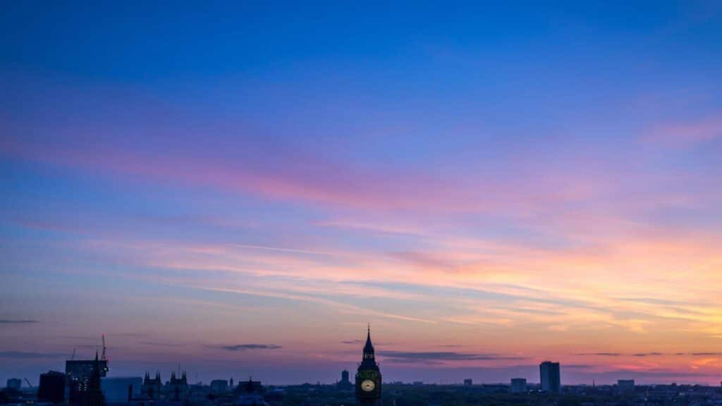 A vibrant sunset over the London skyline with Big Ben visible.