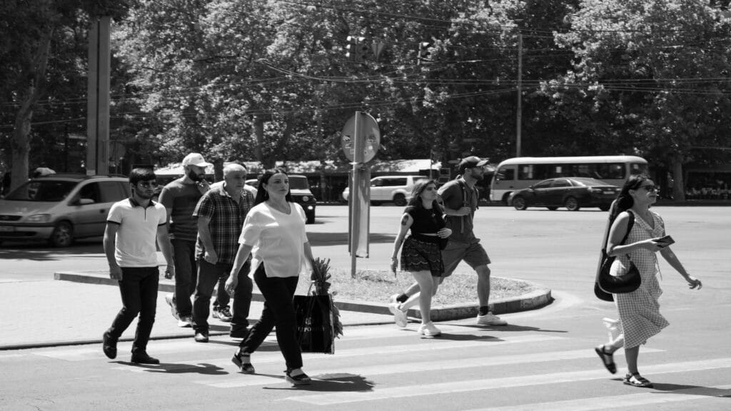 Group of people walking across a crosswalk