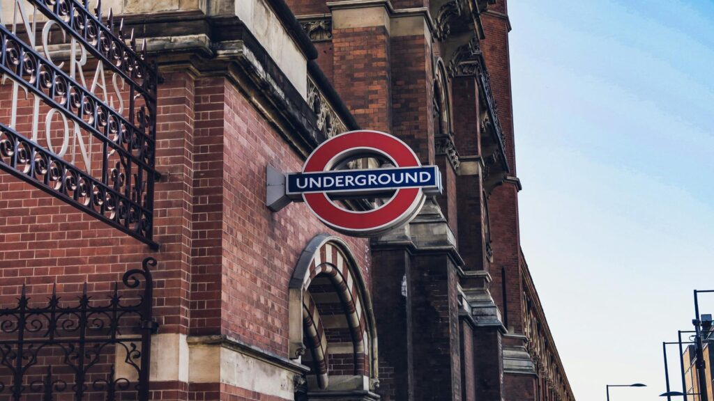 Iconic London Underground roundel sign mounted on red brick Victorian building