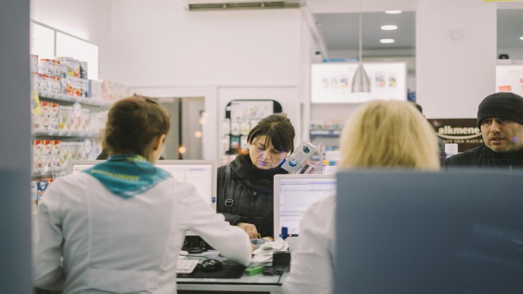 Customers at a pharmacy counter