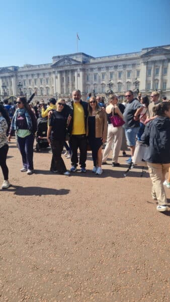 Visitors enjoying Top London Tours in front of Buckingham Palace