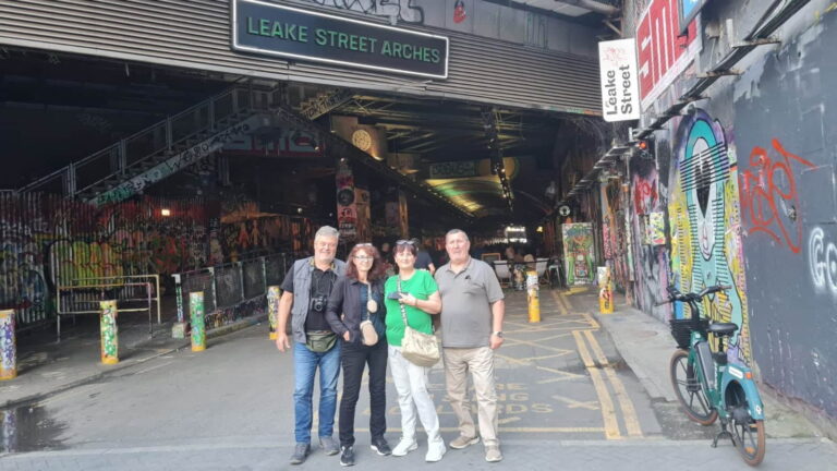 Group of tourists at Leake Street Arches in London, enjoying the Best Taxi Service London