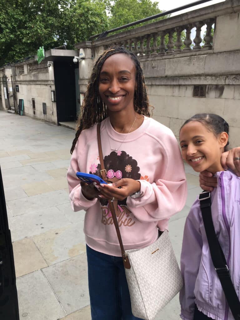 Two visitors smiling during a London Sightseeing Taxi Tour, highlighting London What To See