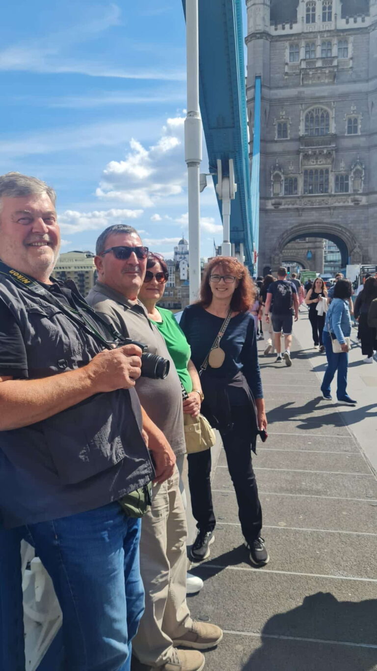 Group of tourists enjoying Black Cab Tours Of London near Tower Bridge