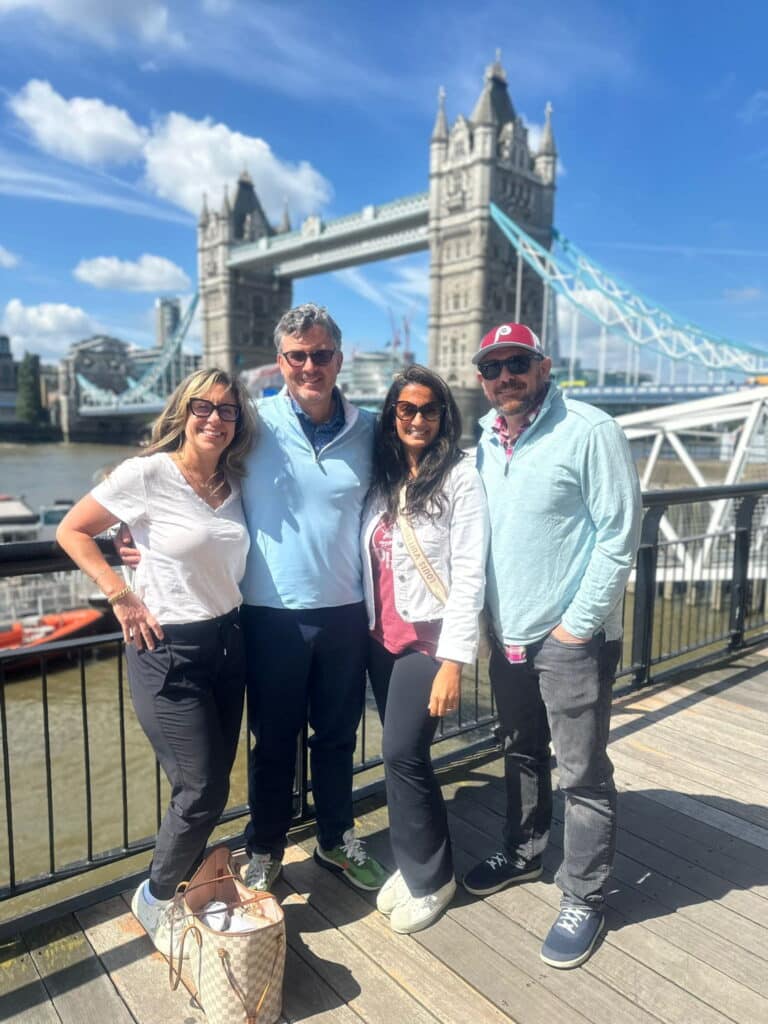 Group of people posing near Tower Bridge during their Trips in London