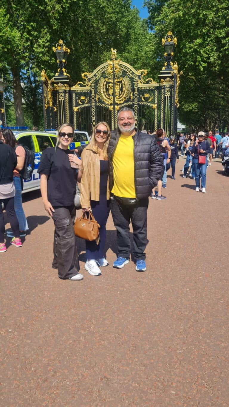 Visitors enjoying a London sightseeing tour near a golden gate, part of a 2 Days In London experience.