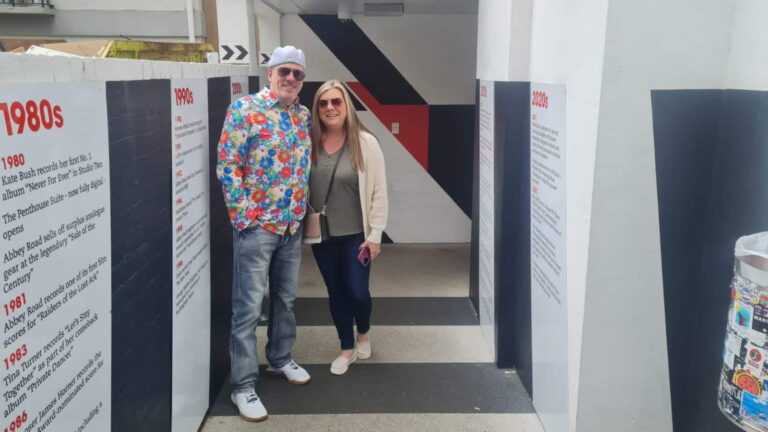 Visitors enjoying Hidden London Walking Tours with historical panels from the 1980s and 1990s.