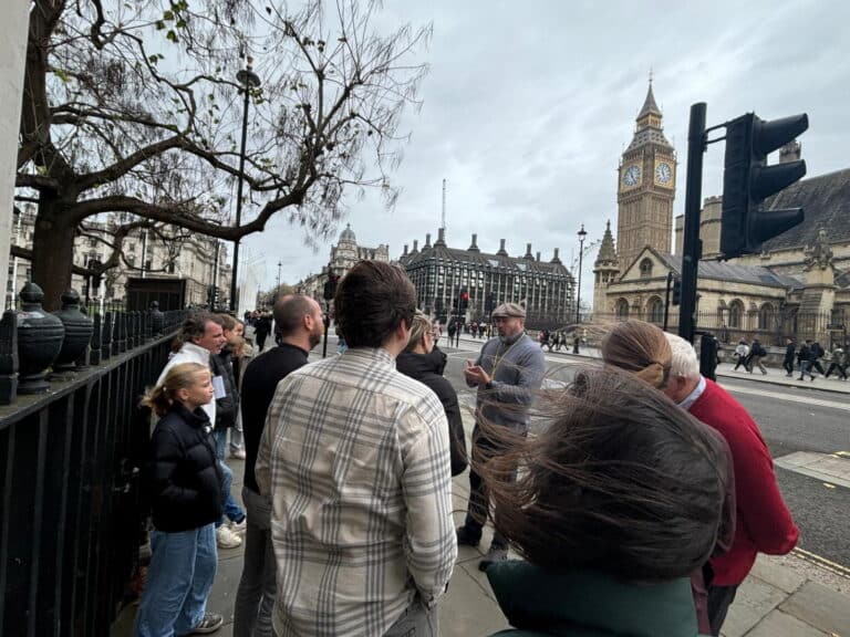 A group of people visiting famous London sightseeing places with Big Ben in the background.