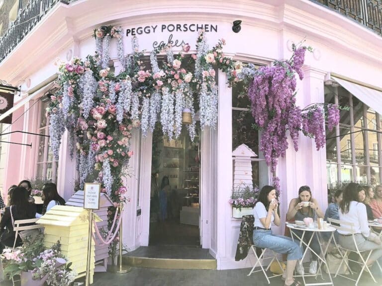 Beautiful pink caf adorned with flowers in London - a must-visit spot for London Where To Go enthusiasts.