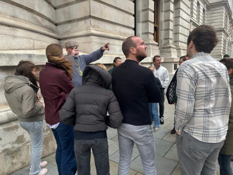 Group of people exploring historical landmarks during guided tours in London England