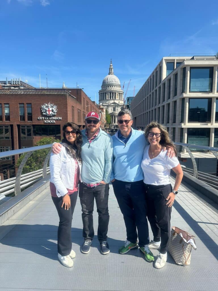 Group of people enjoying sightseeing at Millennium Bridge with St. Paul's Cathedral in the background, showcasing new attractions in London.